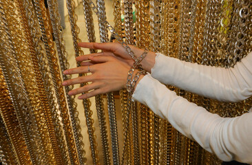 hands of a woman that have been chained and the background of chains - 785638271
