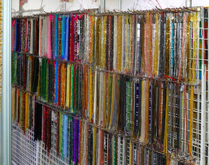 Necklace shop with lots of strands of colorful pearl necklaces in costume jewelry store
