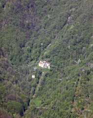 few houses in the remote district in the middle of the woods on the slopes of the mountain - 785645827