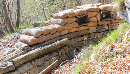 narrow trench dug in the ground and lined with sandbags to protect soldiers from enemies - 785646876