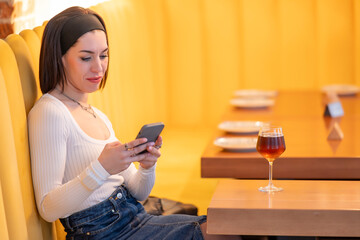 Woman using smartphone in a restaurant