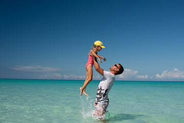 dad with children, playing with kid, family on the beach, swimming in the ocean, vacations in warm...