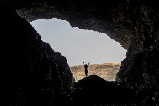 Anonymous woman Celebrating Adventure in Fuerteventura Cave