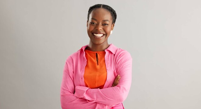Fototapeta Black woman, arms crossed and portrait with smile in studio for fashion, confidence and pride on grey background. African person, happy and face of person with trendy, style and positive mindset