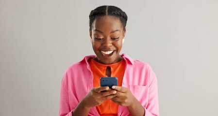 Face, smile or excited black woman with phone in studio for online, competition or giveaway on grey...