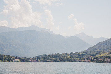 Boat on Lake Como, Italy, mountains and greenery on the background.