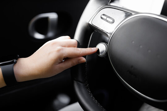 Driving mode button on luxury electric car. Eco mode is a relaxed and comfort sport is a fuel efficient driving mode. Smart electric vehicle concept. Sport Mode button of a car. Pressing the button