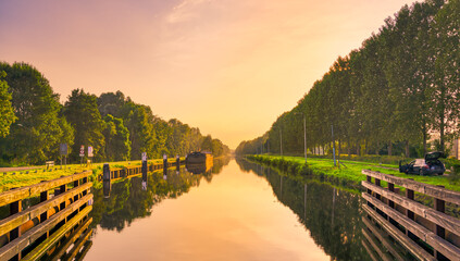 Sunset over the Wilhelminakanaal canal near the village of Beek en Donk, The Netherlands. - obrazy, fototapety, plakaty