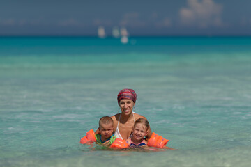 mom with children, playing with kid, family on the beach, swimming in the ocean, vacations in warm countries, Caribbean sea, Atlantic ocean, Cuba, childhood, parents, son