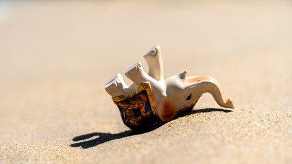 figurine of an elephant on the beach sunbathing