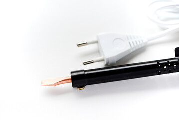 Electric soldering iron with a wooden handle on a white background. A tool for soldering radio...