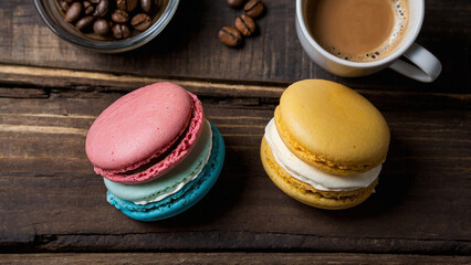 
Pink, blue, yellow macaroons on a plate on a wooden antique background with a cup of coffee and a bowl with coffee beans - Powered by Adobe