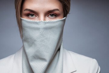 Portrait of a woman with stylish futuristic wild rag covering her face