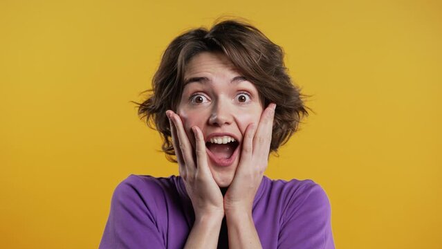Surprised woman, she expresses WOW, cant believe.Impressed pretty lady on yellow