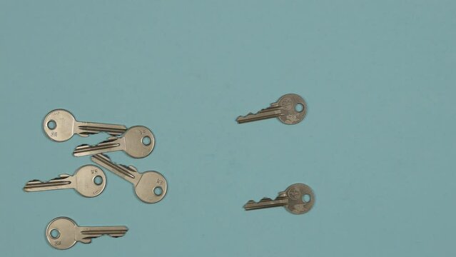 Finding the right key concept. Multiple keys explosion on blue background. Stop motion animation. 4K Stop motion animation.