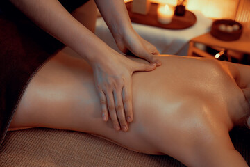 Closeup woman customer enjoying relaxing anti-stress spa massage and pampering with beauty skin...