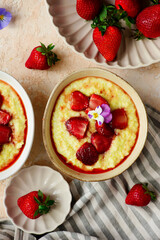 Creamy millet porridge with baked strawberries in to the bowl - 785683809
