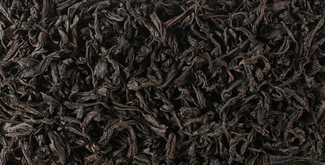 Pattern dry leaves Oolong tea, Camellia sinensis, dark green teas background and texture, top view
