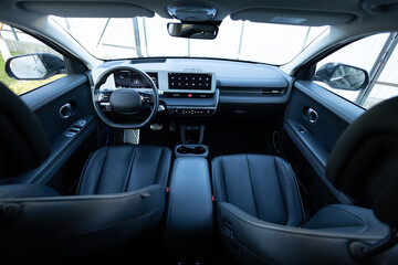 Electric car interior details adjustments. Inside car interior with front seats, driver and...