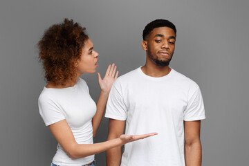 Young black woman arguing with her boyfriend that ignoring her