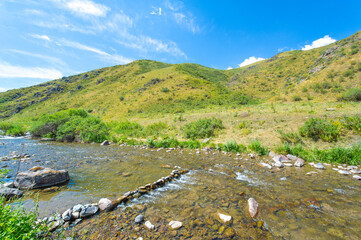 Enjoy the serene beauty of nature. See how the river gracefully flows through the rocky canyon. Be captivated by the majestic mountains surrounding you.