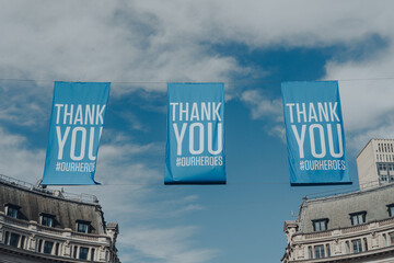 Thank You banners on Oxford Street, London, UK, against the blue sky.