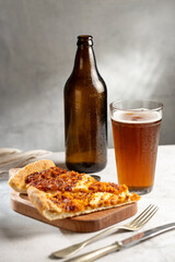 Slices of pizza with glass of beer on the table.