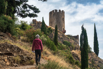 A tourist in the ruins of the medieval castle of Lastours, in the Cathar region of southern France - 785692466