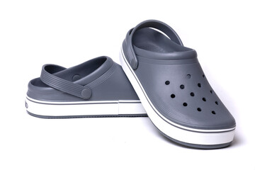 Gray crocs on a white background. Rubber shoes - obrazy, fototapety, plakaty