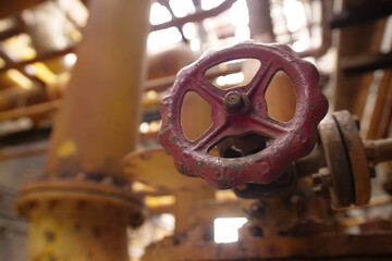 Close up of the red valve on the yellow pipe. the red valve on the yellow tube 