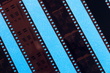 Fototapeta premium 35mm positive filmstrips with empty frames, real scan of film material with cool scanning light interferences on the material. 