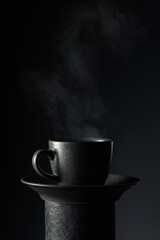 Black cup of coffee on a black background. - 785702619