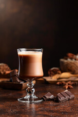  Glass of cocoa drink and pieces of dark chocolate.
