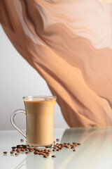 Coffee with cream on a glass table. - 785702665
