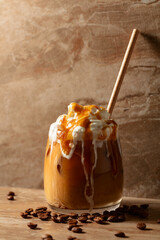 Iced caramel latte topped with whipped cream and caramel sauce.