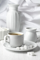 Cup of black coffee and sugar on a white wooden table. - 785702697