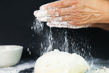Woman's hands knead the dough for baking bread. The chef. Close-up of woman's hands kneading dough