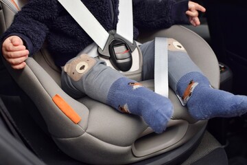 A small child in a special car seat with seat belts.  Child safety while traveling.