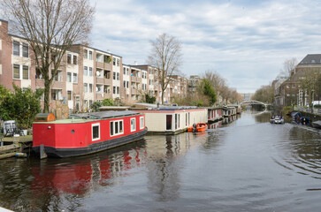 Fototapeta na wymiar Floating houses along the Amsterdam canal. 2024 March 03