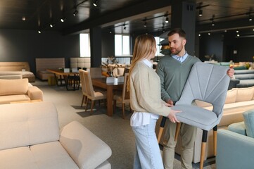 Attractive woman with her husband at the furniture store showroom