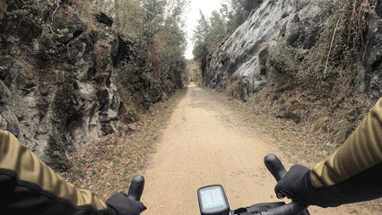 Rider point of view of a gravel bike riding on sandy rural countryside path