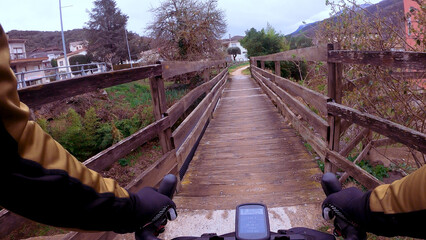 Crossing a tight wooden bridge with a gravel bicycle rider point of view