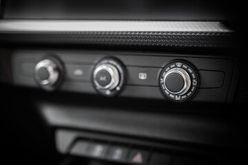 Car air conditioning system buttons, dials closeup. Warm and cool settings.