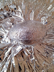 Easter egg wrapped in silver color foil