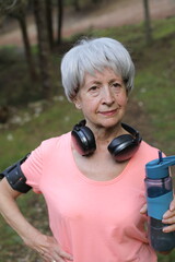 Senior active woman holding water bottle