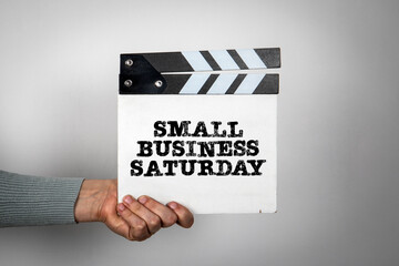 Small Business Saturday. Hand holding movie clapper - 785722420