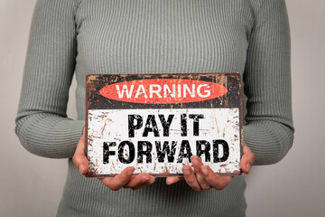 Pay It Forward. Warning sign with text woman in hand - 785722422