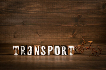 TRANSPORT. Text from alphabet blocks and rusty miniature bicycle on wood texture background - 785722473