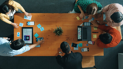 Programmer sharing Ux Ui design for mobile phone interface idea with software developer at meeting...