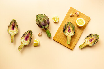 Fresh raw artichokes with lemon and garlic ready for cooking